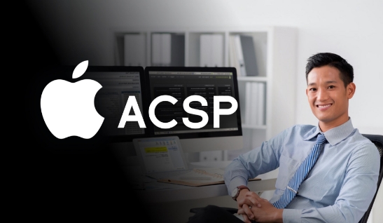 A man sitting in front of two computers.